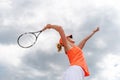 Tennis serve by a young woman in a tournament