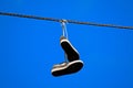 Tennis shoes hanging from a power line Royalty Free Stock Photo