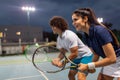 Tennis sport people concept. Mixed doubles player hitting tennis ball with partner standing near net Royalty Free Stock Photo