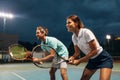 Tennis sport people concept. Mixed doubles player hitting tennis ball with partner standing near net Royalty Free Stock Photo