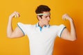 Tennis, sports and man flexing arms with fitness and workout on yellow background. Person, model and athlete with Royalty Free Stock Photo