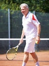 Tennis, sports and senior man on court for playing game, match and practice for competition. Retirement, happy and