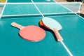 Tennis table with rackets. Bright green table with orange ball and white net. Activities and sports. Banner in a sports shop. The Royalty Free Stock Photo