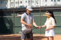 Tennis training. Professional coach learning woman how to play. Tennis trainer showing sports woman correct position on