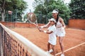 Tennis training for young kid. Full length shot of female tennis coach training little girl in sport club. Tennis instructor with Royalty Free Stock Photo