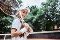 Tennis training for young kid outdoors. Portrait of happy sporty little girl on tennis court. Caucasian child in white tennis Royalty Free Stock Photo