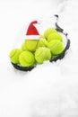 Tennis winter concept with tennis balls and racket on white snow, isolated. Royalty Free Stock Photo