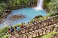 tourists watch from a platform the scenic waterfall in tenorio volcano national park