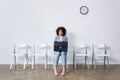 Tense businesswoman with briefcase sitting on chair