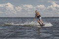 Tense man wakeboarding in a lake and pulled by a boat Royalty Free Stock Photo