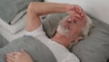Tense Old Man Feeling Uncomfortable while Sleeping in Bed Royalty Free Stock Photo