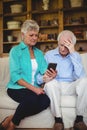 Tense senior couple looking at mobile phone Royalty Free Stock Photo