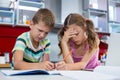 Tense siblings doing homework in kitchen Royalty Free Stock Photo