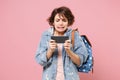 Tense young woman student in denim clothes backpack isolated on pastel pink background in studio. Education in high