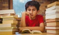 Tensed boy sitting with stack of books Royalty Free Stock Photo