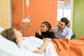 Tensed Couple Looking At Senior Mother In Hospital Royalty Free Stock Photo