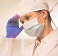 Close-up of tensed dentist wearing surgical gloves and mask