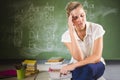 Tensed school teacher sitting in classroom