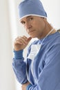 Tensed Surgeon Standing In Hospital