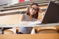 Tensed woman using laptop in classroom