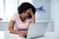 Tensed woman using laptop