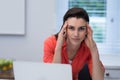 Tensed woman working on laptop