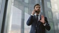 Tensed worker talking phone in office closeup. Serious man finish telephone call Royalty Free Stock Photo