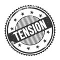 TENSION text written on black grungy round stamp