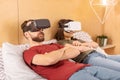 Attractive collected couple watching thriller in VR
