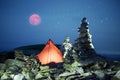 Tent alpine starry night and Red Moon Royalty Free Stock Photo