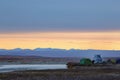 Tent camp and all-terrain vehicle in the tundra near the river. Morning autumn Arctic landscape.