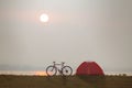 Tent camp and bicycle beside the lake with sunset Royalty Free Stock Photo