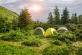 Tent camp in the forest in the Carpathian mountains on slopes of Hoverla Royalty Free Stock Photo