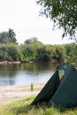 Tent camp on the river bank. A fragment of the tent is visible. Medium plan Royalty Free Stock Photo