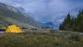 Tent at camp site in the middle of rocky mountains Royalty Free Stock Photo