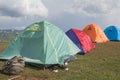 Tent camping in mountains concept. Tourist tent in camp among meadow in the mountain Royalty Free Stock Photo