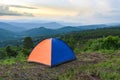 Tent camping on the mountains landscape background - adventure travel camping tent in summer season
