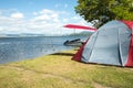 Tent on a camping site near a lake Royalty Free Stock Photo