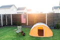 Tent, folding chair and guitar on the lawn