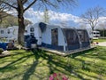 A tent in front of a travel trailer at a campsite, Caravan camping, Relaxing campsite, Trailer park, Summer Camping