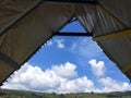 Tent on the hill in the countryside with clear blue sky and white clouds. of Indonesia Royalty Free Stock Photo