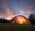 Tent with light inside at dusk near the Grand Teton mountains Royalty Free Stock Photo