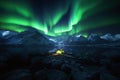 Tent with light inside under stunning Auroras in snowy mountain landscape