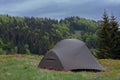 Tent on mountain col in grass in the morning. On background Mala Fatra mountains, Slovakia Royalty Free Stock Photo