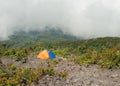 Tent on the mountain in fog and clouds. Volcano Mount Merapi.