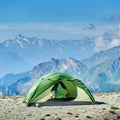 Tent, mountain landscape on background.