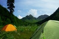 Tent in mountains with beautiful summer landscape Royalty Free Stock Photo