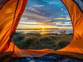 Tent nestled in woodlands with a view of sunset reflecting on tranquil waters Royalty Free Stock Photo