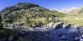 Tent next to glacial river in mountain landscape near refuge Wallon Marcadau in French Pyrenees, France, Europe