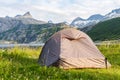 Tent in norwegian fjord landscape with mountains in the background on a sunny summer day Royalty Free Stock Photo
